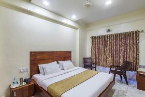 a bedroom with a large bed and a window at Hotel Sky in Dwarka