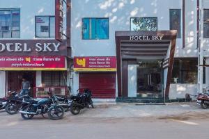 a group of motorcycles parked in front of buildings at Hotel Sky in Dwarka