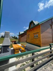 a wooden cabin with a fireplace and a picnic table at Villa Lux in Žabljak
