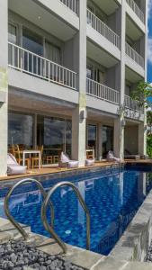 a large swimming pool in front of a building at Shashvata Berawa in Badung
