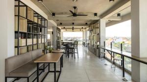 a restaurant with tables and chairs and a balcony at Shashvata Berawa in Badung