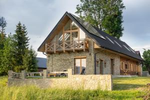 a house with a solar roof on top of it at Ad Matrem in Zubrzyca Dolna