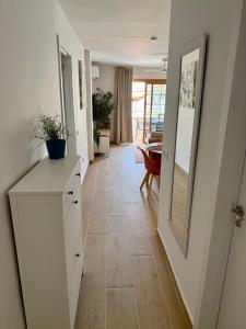 a hallway with a white cabinet and a mirror at Pool View Apartment Garden City in Costa de Adeje