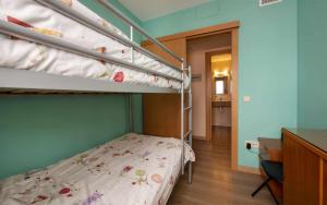 a bedroom with two bunk beds and a desk at Miquel 2 – Apartamento con Parking, Wifi y A/C in Tossa de Mar