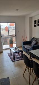 a living room with a couch and a table at B & V departamentos in San Salvador de Jujuy +18 photos