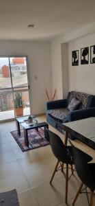 a living room with a couch and a table at B & V departamentos in San Salvador de Jujuy