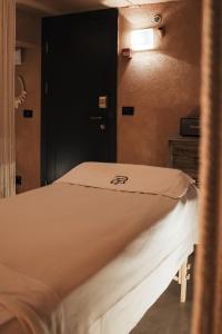 a bed in a room with a black door at Casa Suzanna Hotel in Tel Aviv
