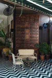 a living room with two chairs and a table at Casa Suzanna Hotel in Tel Aviv