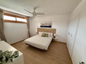a bedroom with a bed and a window at Pool View Apartment Garden City in Costa de Adeje