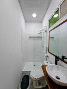 a bathroom with a toilet and a sink and a shower at Suite Meridiano Direct Beach Access y AC in Ballenita +14 photos
