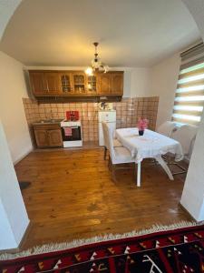a living room with a table and a kitchen at Canovic vacation in Plav