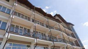 a facade of a building with balconies at Warszawa Hotel in Lviv