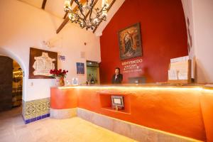 a man is standing behind a counter in a building at San Agustin Monasterio de la Recoleta in Urubamba