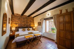 a bedroom with a large bed and a window at San Agustin Monasterio de la Recoleta in Urubamba +53 photos