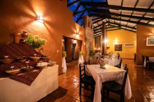 a dining room with tables and chairs in a building at San Agustin Monasterio de la Recoleta in Urubamba
