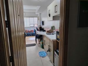 a kitchen with a sink and a counter top at Tala Transient House in Baguio