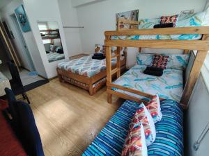 a bedroom with two bunk beds and a bed at Tala Transient House in Baguio +4 photos