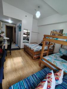 a room with two bunk beds and a table at Tala Transient House in Baguio