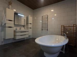 a white bathroom with a tub and a sink at Villa ZRUB in Palyanytsya +37 photos