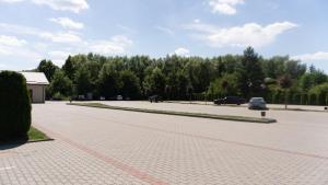 a parking lot with cars parked in a parking lot at Warszawa Hotel in Lviv +75 photos