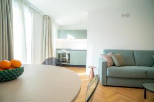 a living room with a table and a couch at Appartamento Costanza in Letojanni +6 photos