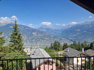 a view of the mountains from the balcony of a house at Chalet du Sky PILA in Cerise