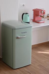 a small refrigerator with a tea kettle on top of it at Villa Grazia in Oliveto Citra
