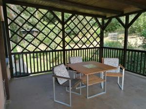a wooden table and chairs on a gazebo at Penzion Janata in Slapy +56 photos