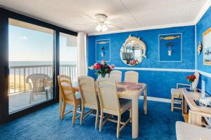 a dining room with a table and a view of the ocean at Sea Watch 1910 in Ocean City