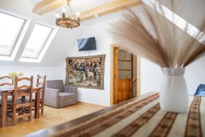 a living room with a table and a vase at Ad Matrem in Zubrzyca Dolna