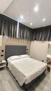 a bedroom with a large bed in front of a window at Da Gianni Hotel in Zogno