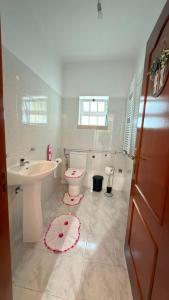 a white bathroom with a sink and a toilet at Recanto da Paz in Pombal +22 photos