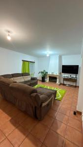 a living room with a couch and a television at Recanto da Paz in Pombal
