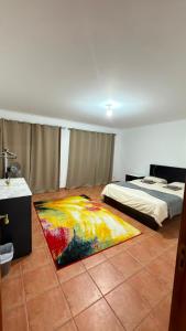 a bedroom with two beds and a rug on the floor at Recanto da Paz in Pombal