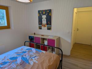 a bedroom with a bed and a painting on the wall at Chambres indépendantes chez l'habitant in Saint-Pierre-dʼAlbigny +7 photos