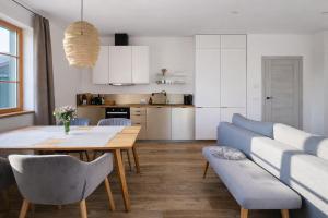 a kitchen and dining room with a table and chairs at Šalet Hrabětice in Janov nad Nisou