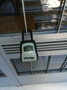 a tv hanging from a window with the word massachusetts at Rooms in Central Athens in Athens