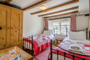 a bedroom with two beds and a window at 2 Bed in Askrigg oc-ds778 in Askrigg