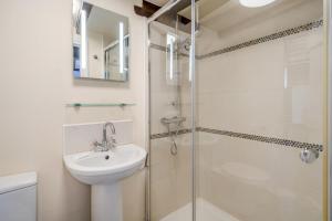 a white bathroom with a sink and a shower at 2 Bed in Askrigg oc-ds778 in Askrigg +17 photos