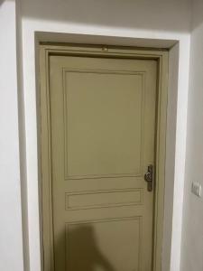 a door in a room with a white wall at Perfect Stay Apartment 10 min to airport ibn battouta and beach in Tangier