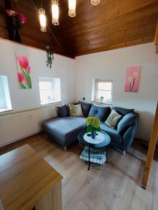 a living room with a couch and a table at Tinyhouse Loisl in Thyrnau
