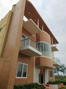 a brick building with balconies on the side of it at Krishibid Resort  +5 photos