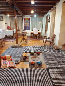 a living room with several rugs on the floor at Orchard Huts in Chamba