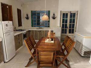 a kitchen with a wooden table and chairs in it at Apart Santa Ana in Santa Ana