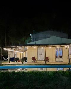a house with a swimming pool at night at Apart Santa Ana in Santa Ana