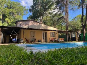 a house with a pool in front of it at Apart Santa Ana in Santa Ana