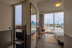 a hotel room with a bed and a view of a city at Prano Hotel in Bangkok