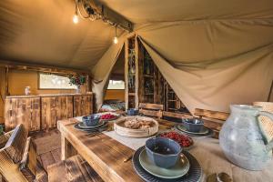 a table with plates of food on top of a tent at Dworska Polana in Szteklin