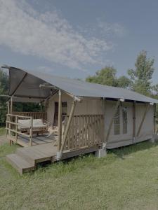 a large tent with a porch and a table at Dworska Polana in Szteklin