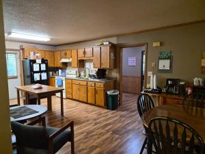 a kitchen with wooden cabinets and a table and chairs at Drayton Inn in Drayton
